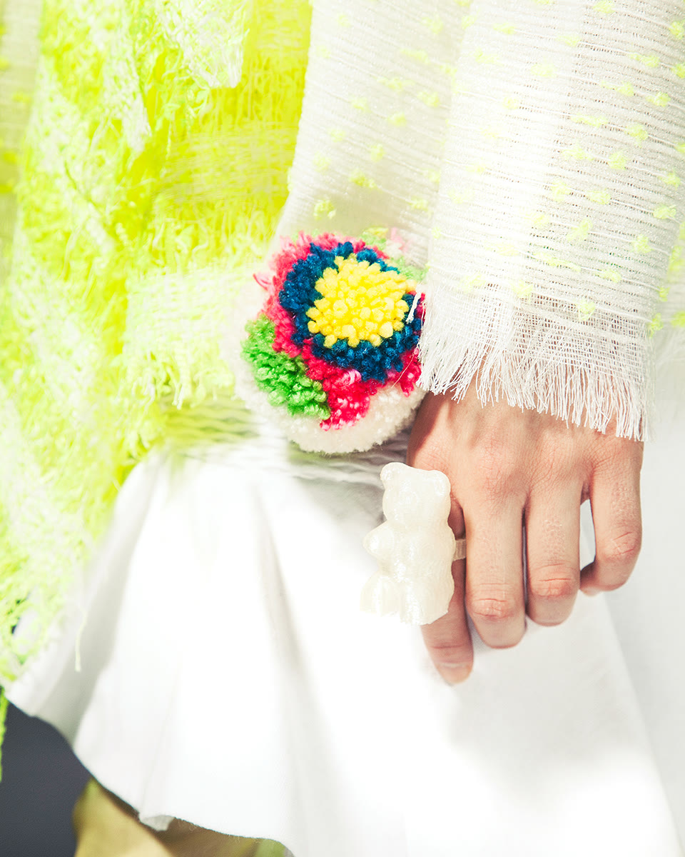 Close-up of cuff finishing and accessory integration in knitwear look