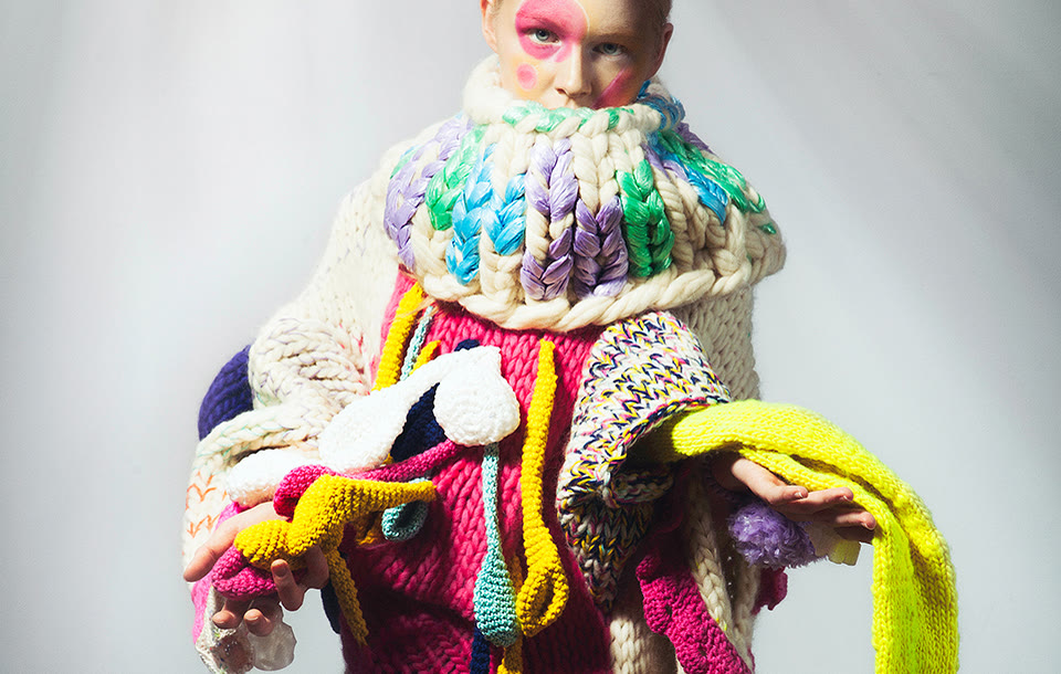 Technical close-up of oversized knit construction and applied elements