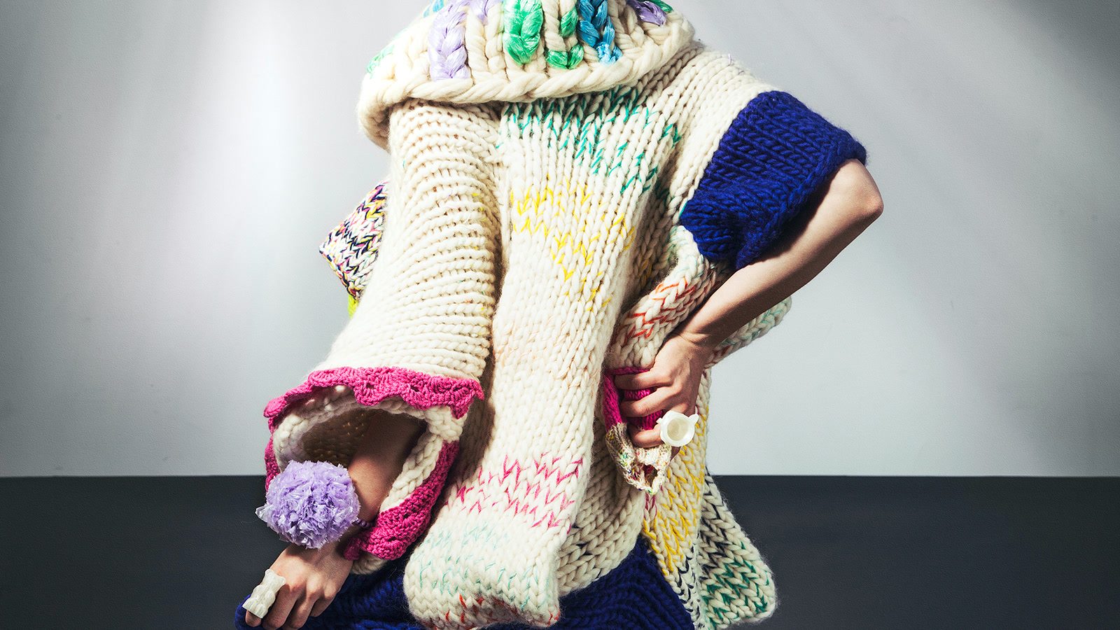 Close view of a multicolour chunky knit combining smooth, twisted, and textured yarns